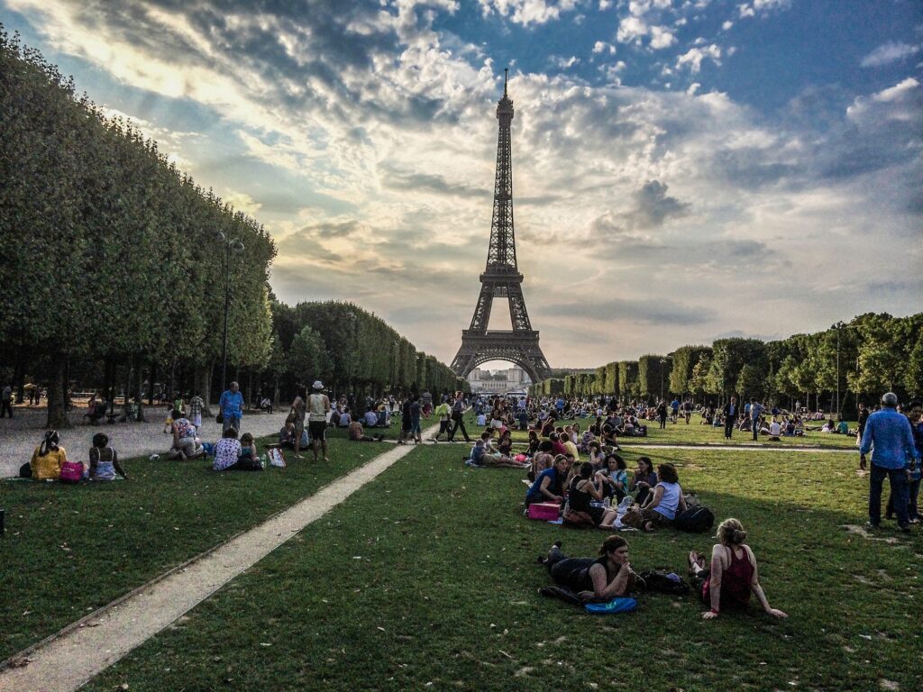 At the Eiffel tower in Paris, France Gorgeous white girl posing in amusement park with kissing face expression | SUPERPOBYT Travel