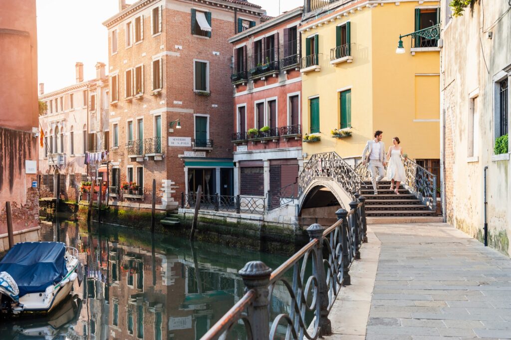 Italy, Venice, bridal couple walking on little bridge | SUPERPOBYT Travel